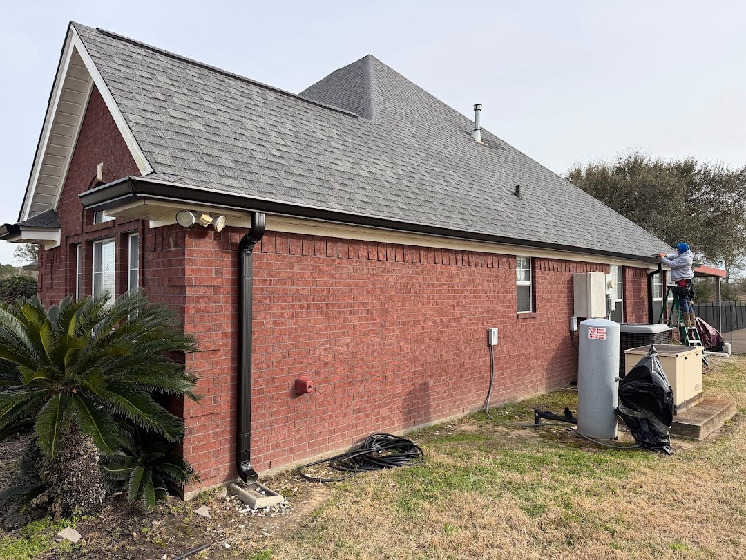 Seamless gutter installation on large brick home in Groves, TX
